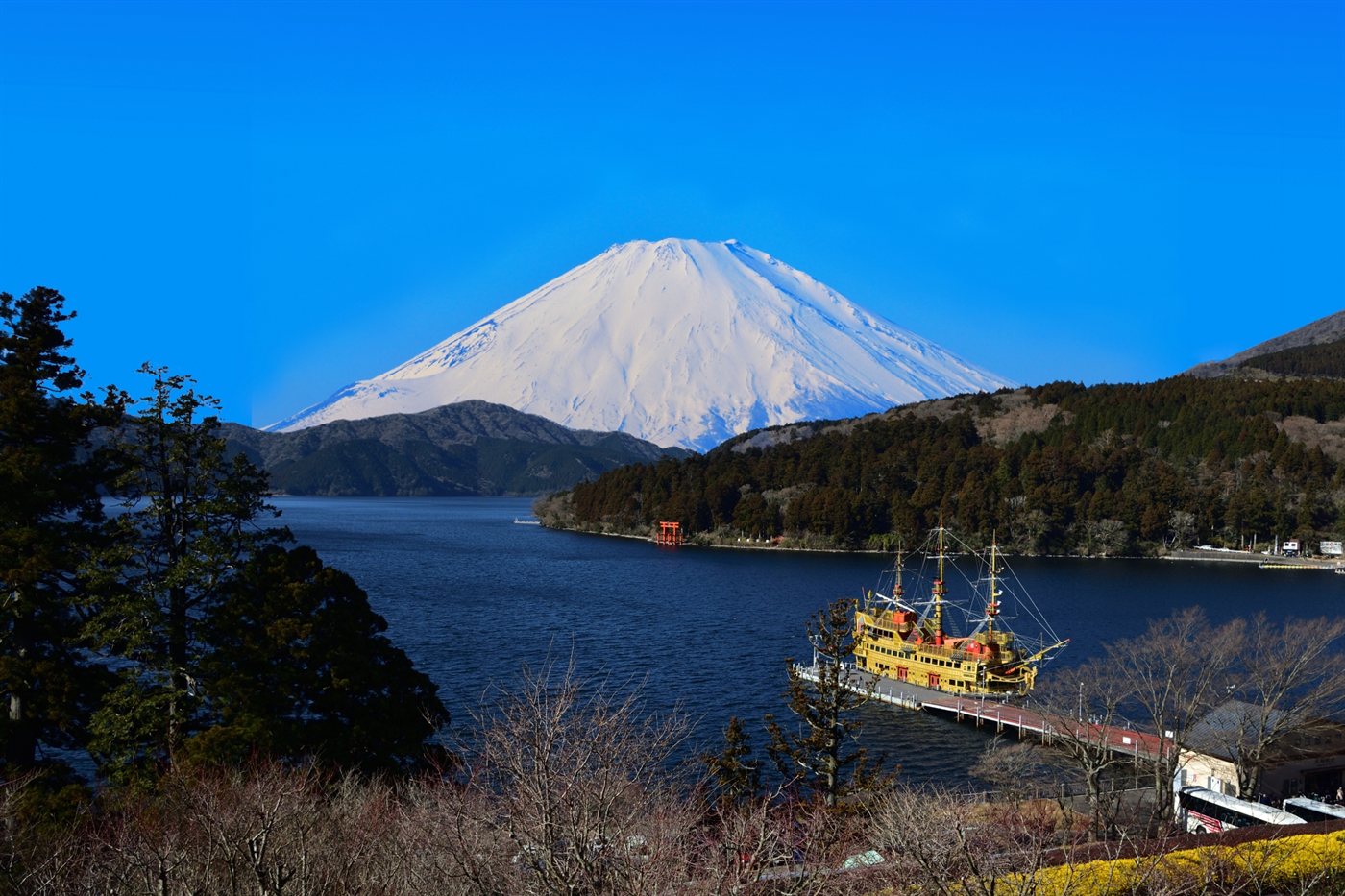 Mount Fuji seen across Lake Ashi in winter with a sightseeing boat